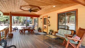 A wooden deck with outdoor furniture, including a rocking chair, a sofa, and a table. - (36) Larkspur Lair at The Redwoods In Yosemite (Yosemite National Park)