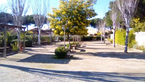 An outdoor area with a paved walkway, benches, and trees. -  * RUNNING AND WALKING BEACH * enclosed garden * CLIM * WIFFI * PARKING * (Saint-Cyprien)