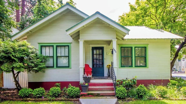 A two-story house with a front porch, a red door, and green shutters. - Best Place / Best Condition / Best Price !!! Go to everything !!! (coeur d alene)