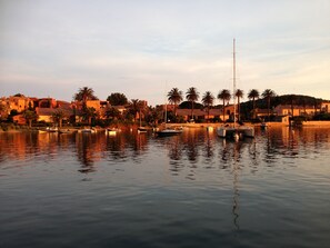Enjoy waterfront views and tranquil surroundings, with boats moored along the shore.