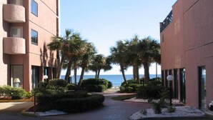 A pathway leading to a building with a view of the sea. - Amazing Views - Ocean Front 3BR Condo! (Myrtle Beach)