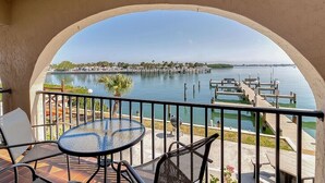 A balcony with a view of a marina and water.