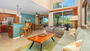 A spacious living area with a dining set, a sofa, and a coffee table. - Hilton Waikoloa Pool Pass for stays in 2026/Waikoloa Golf Discounts (Waikoloa Beach Resort)