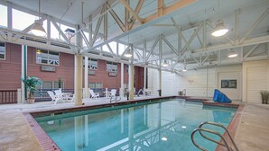 An indoor swimming pool with a clear view of the pool area, lounge chairs, and a covered section. - Park City Resort Ctr 3BR 2Ba Walk2Ski; Free bus Main St; Hot Tub; Winter Pool (Park City)