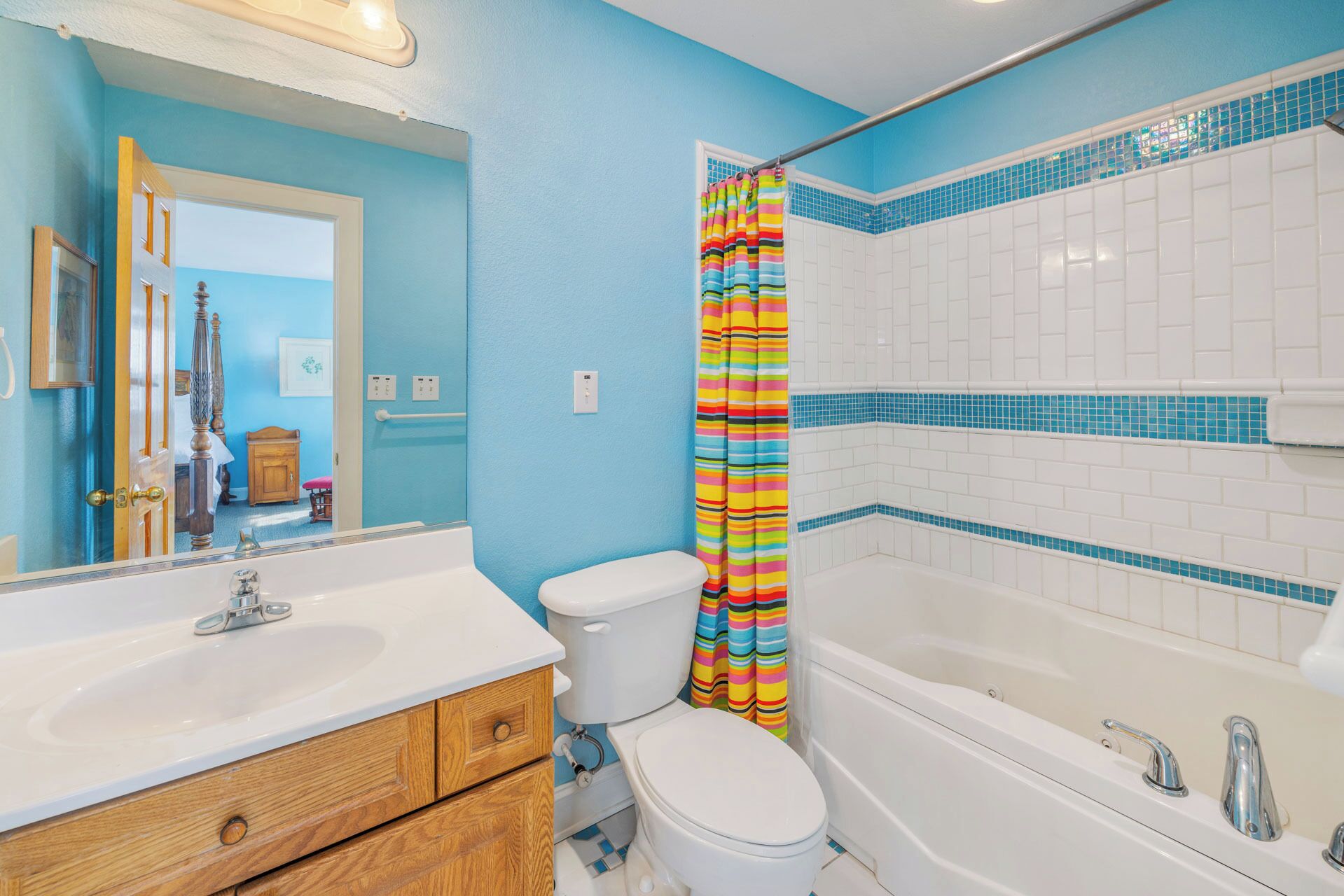 A bathroom with a white bathtub, a toilet, and a sink.
