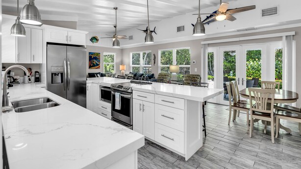 A modern kitchen with white cabinetry, stainless steel appliances, and pendant lighting. - Coral Cove Resort - ‘A Fisherman’s Dream’ (Islamorada)