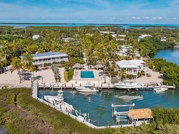 A coastal property with a marina, swimming pool, and tropical vegetation.