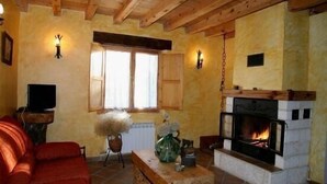 A cozy living room with a fireplace, a sofa, a coffee table, and a television. - Roblejimeno Country House - 2026 Solar Eclipse Special - Solar Eclipse Spain 2026 (Cubillo del Cesar)