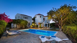 A swimming pool with lounge chairs and a stone patio. - Spacious sea view studio  ATHENA  for 2-3 persons in Rhodes - Ialysos (Rhodes)