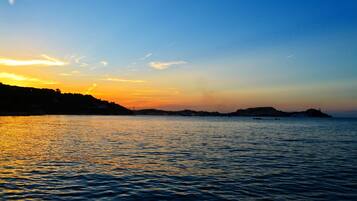 On the beach, sun-loungers