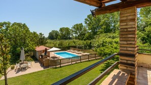 A backyard with a swimming pool, a barbecue area, and a wooden deck. - Self catering Can Salvà for 12 people (Vilobí d'Onyar)