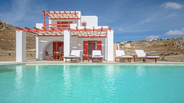 A modern building with a pool, white walls, red accents, and outdoor seating. - DUNES Villa with Private pool for 6 (Naxos)
