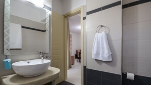 A bathroom with a large white sink, a mirror, and a towel rack. - DUNES Villa with Private pool for 6 (Naxos)