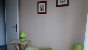 A bedroom with a bed, two bedside tables, a door, and two framed pictures on the wall. - "Les Rousserolles"- Between LAC du BOURGET and CHAMBERY, T 2 (64m2), 3 stars NN (La Motte-Servolex)