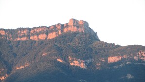 A mountain with a cross on top, surrounded by dense forest. - "Les Rousserolles"- Between LAC du BOURGET and CHAMBERY, T 2 (64m2), 3 stars NN (La Motte-Servolex)
