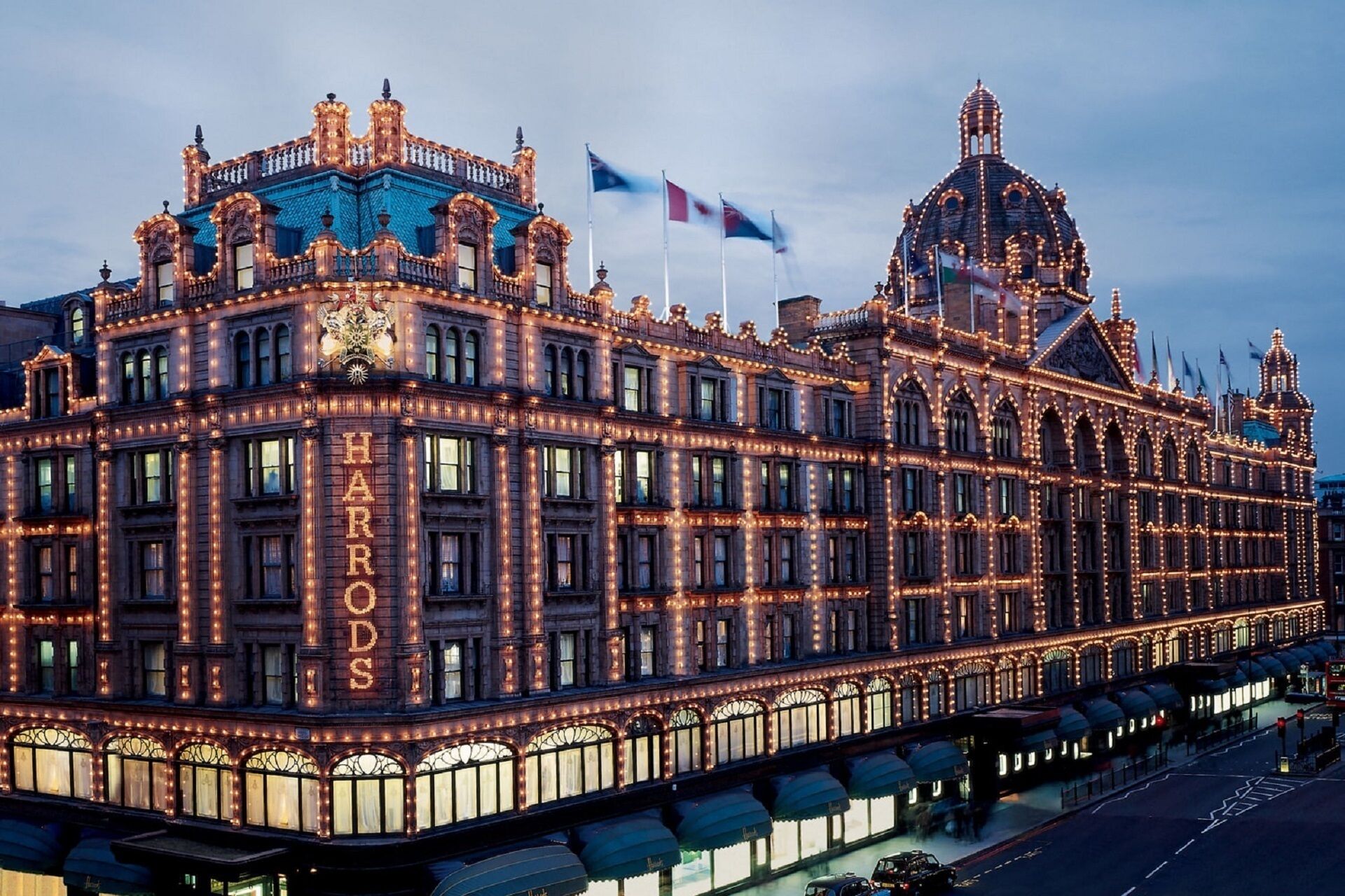 A large, ornate building with the name "HARRODS" prominently displayed on its facade.