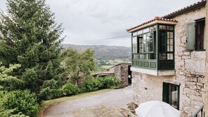 A stone building with a balcony overlooking a lush garden and a valley. - Casa da Labaceira (for 7 people) (Cerdedo)