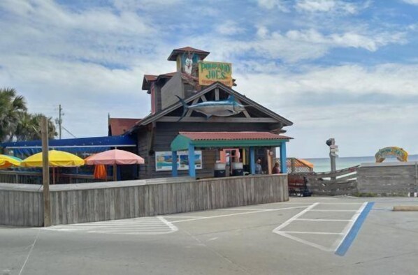 A beachfront building with a sign that reads 'Joe's'.