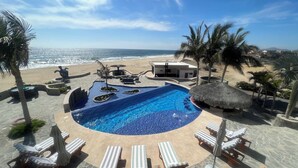 A pool area with lounge chairs, a small pool, and a beach view. - "Villa Rocas" Beachfront Luxury Villa (El Pescadero)