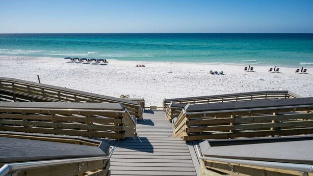 A wooden boardwalk leading to a beach with white sand and clear blue water. - 3BR condo near beach w/ screened patio (Santa Rosa Beach)