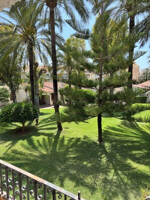 A well-maintained garden with various trees and a neatly trimmed lawn.