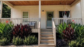 A wooden cabin with a porch, steps, and a door. - Spacious Open-Concept Durham Home (Durham)