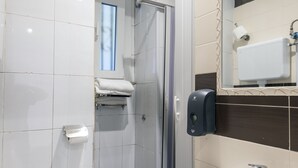 A modern bathroom with a toilet, sink, and shower. - Casa Vacanze Carolina 348 (Naples)