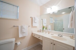 Bathtub, hair dryer, towels, shampoo