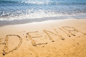 A sandy beach with the word "DENIA" written in the sand. - 0681 Villa Molins Libra (Denia)