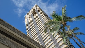 A tall building with a modern design, featuring a grid-like facade and multiple windows. - ”Old Hawaii" Great Location at Waikiki (H7) (Honolulu)