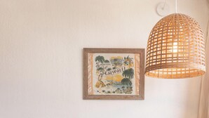 A small wooden table with two chairs, a woven pendant light, and a framed tropical artwork on the wall. - ”Old Hawaii" Great Location at Waikiki (H7) (Honolulu)
