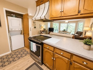 A kitchen with wooden cabinets, a stainless steel oven, and a built-in microwave.