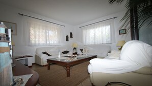 A living room with a sofa, armchair, coffee table, and a lamp. - beautiful detached villa with private pool wi-fi (Briatico)
