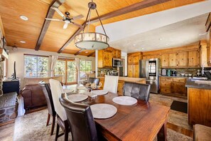 A spacious kitchen with wooden cabinets, a central island, and modern appliances.