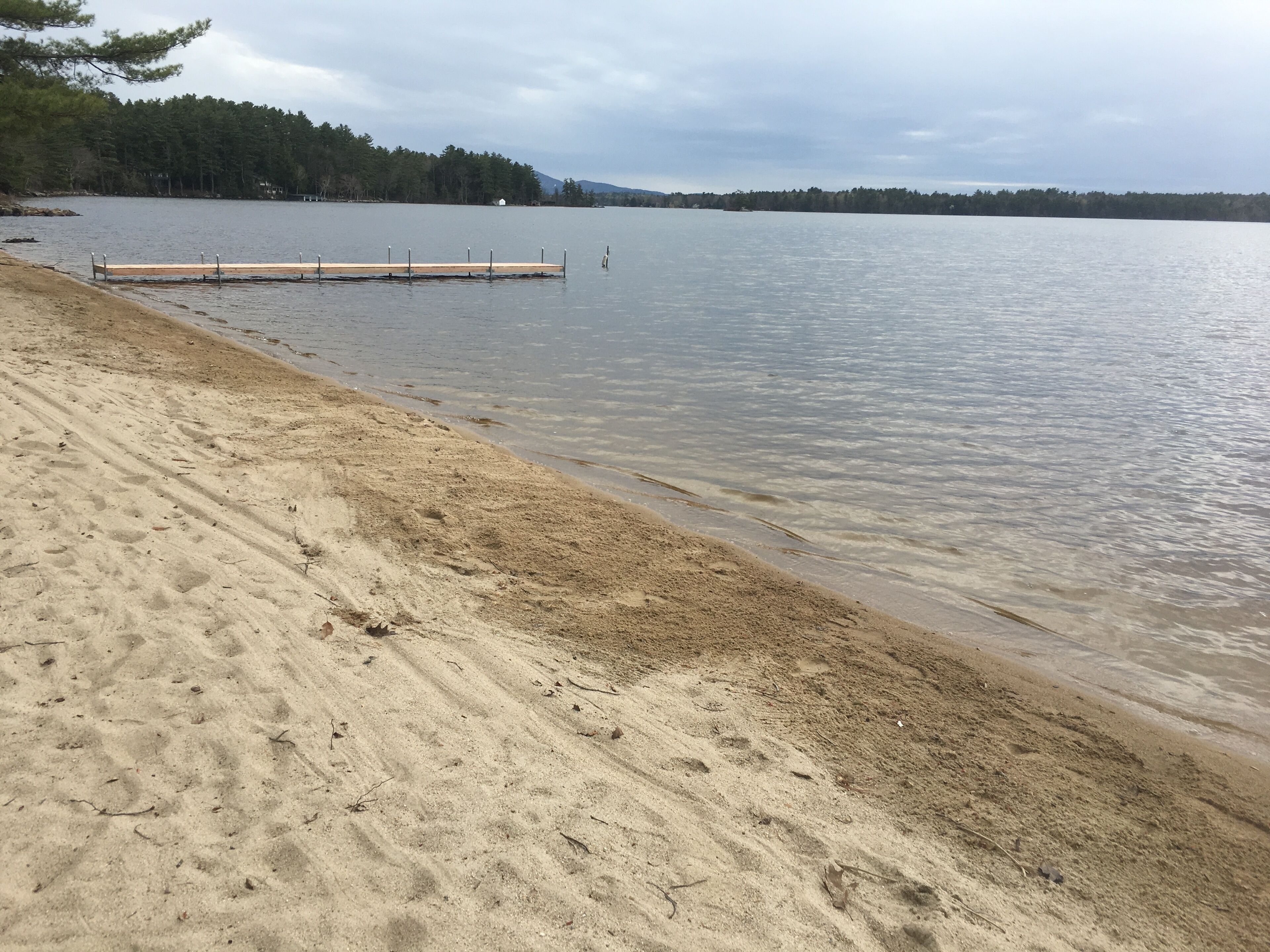 Waterfront Lake Winnipesaukee cabins on private sandy beach with dock