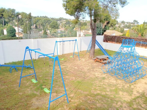 A playground with swings and a climbing structure. - 0304 Monte Verde Naranja (Javea / Xàbia)