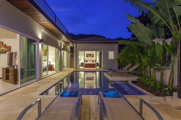 The view from the outside dining area across the pool towards the master bedroom suite