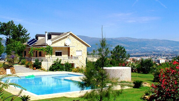 A house with a swimming pool, solar panels, and a view of distant mountains. - Villa De Rêve with Pool XXL (Fundao)