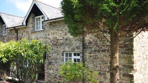 A stone building with a gabled roof, a small porch, and a sign that reads "Dine". - Corffe Cottages, Space for all the family, heated indoor pool (Barnstaple)