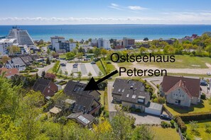 A residential area with houses and a view of the sea.