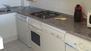 A compact kitchen with white cabinets, a gas stove, a dishwasher, and a washing machine. - PRIVATE ACCESS TO BEACH IN THE SAME URBANIZATION (El Campello)