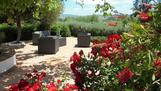 An outdoor seating area with planters and a view of the landscape. - A comfortable country house situated in the Natural Park, Sierra de Grazalema. (Grazalema)