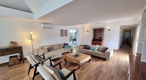 A spacious living area with a sofa set, a coffee table, and a cabinet.