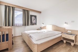 Relax in this serene bedroom with a large bed, bedside tables, and a framed artwork.