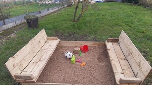 A sandbox with wooden benches and toys. - Pretty fisherman's house (Ault)