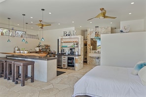 A modern hotel room with a bar area, a bed, and a dining space. - Stunning Private Wine Country Estate - Epic Views - Pool - Hot Tub - Sunsets! (Sonoma)