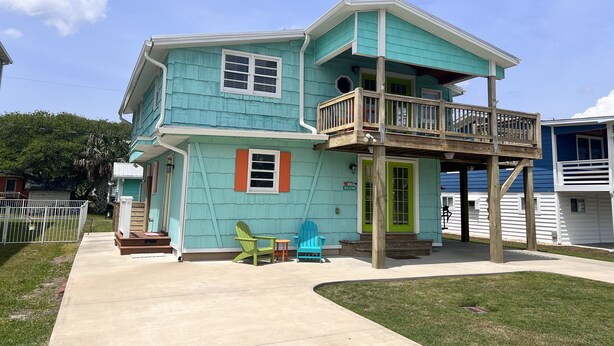A two-story house with a balcony and a porch.
