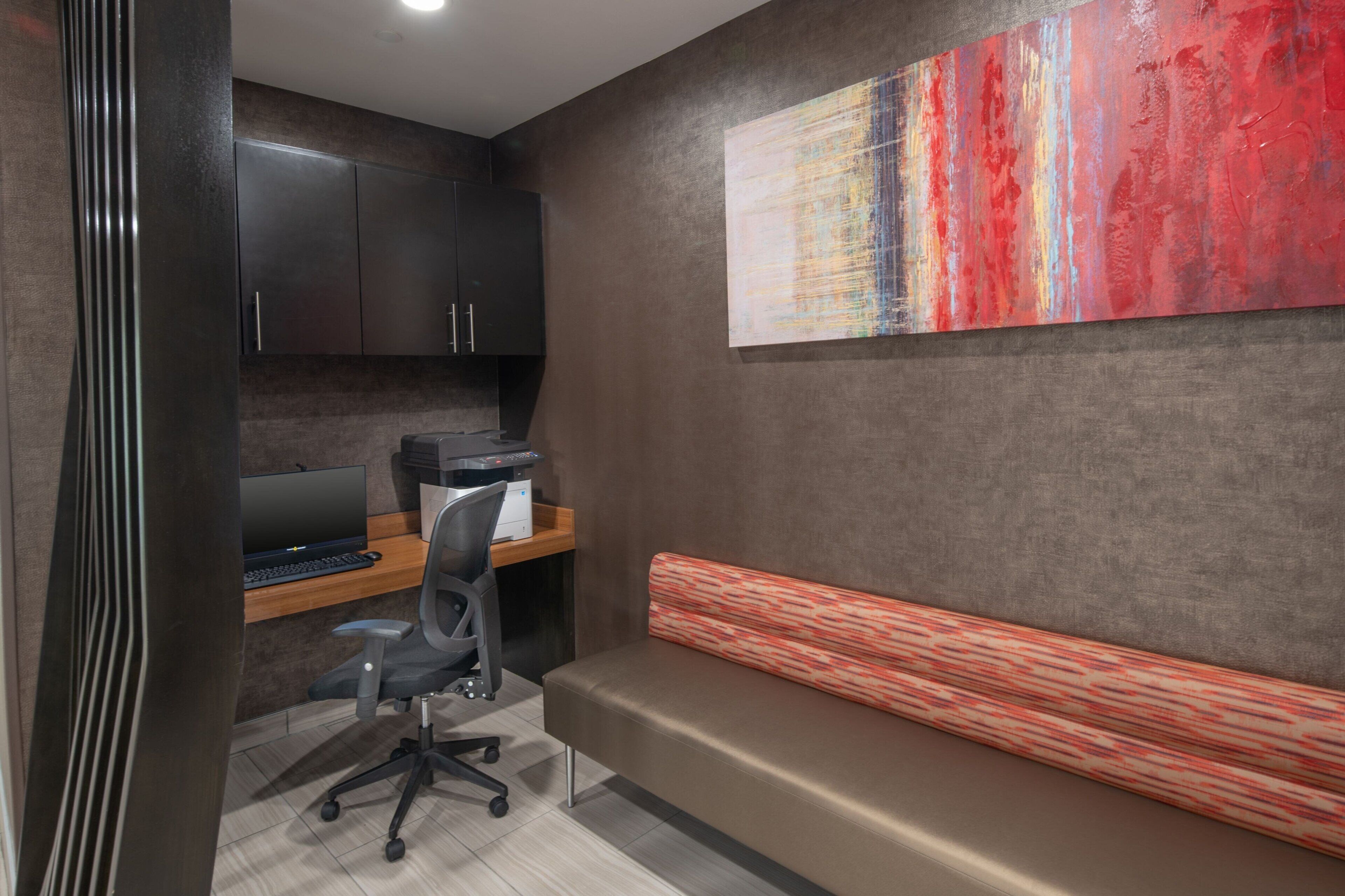 A modern office space with a desk, computer, and office chair.