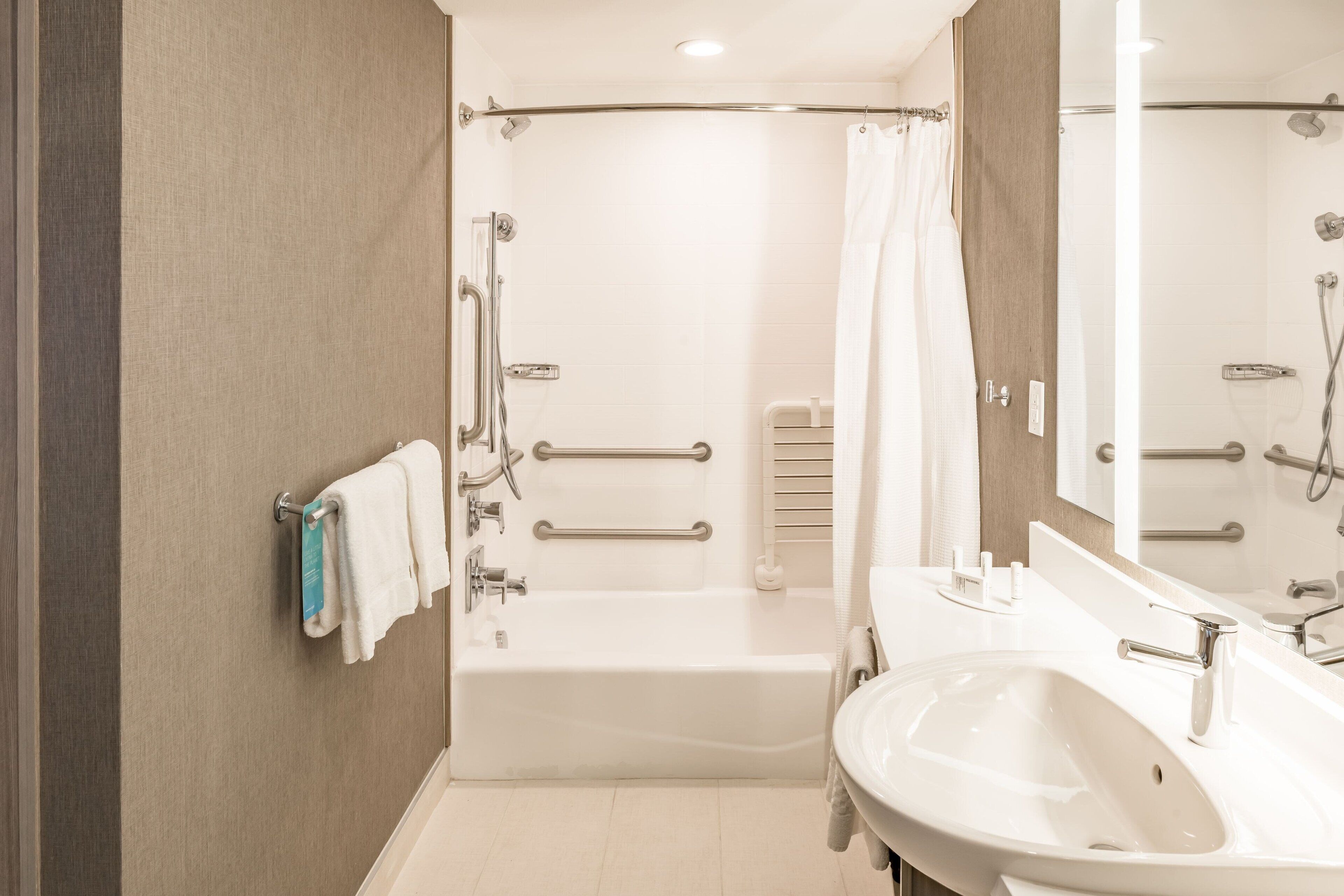 Un bagno moderno con vasca, doccia e lavandino.