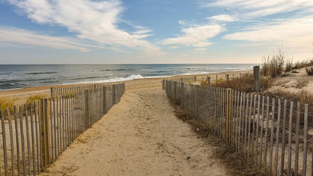 A sandy beach path with a wooden fence leading to the ocean. - Direct Ocean Front Building, Oceanview, Mid-Town 39th St, First Floor Unit  (Ocean City)